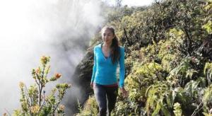 a woman walking on the side of a mountain at Volcano House in Volcano