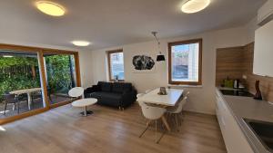 a kitchen and living room with a couch and a table at Rezidence Pavlov in Pavlov