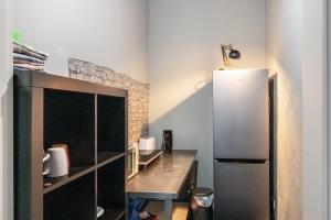 a kitchen with a refrigerator and a wooden table at Unterkunft Fischerbrücke in Wolfenbüttel +19 photos