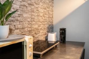 a kitchen with a brick wall and a coffee maker at Unterkunft Fischerbrücke in Wolfenbüttel