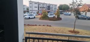 a view of a parking lot with cars parked at Northview APARTMENTS SELF CATERING in Pretoria