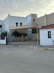 a white building with a parking lot in front of it at marjan beach in Dhahran +9 photos