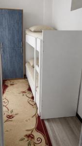 a white bunk bed in a room with a door at Global Hostel 3 in Almaty