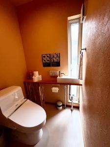 a bathroom with a white toilet and a sink at Ajito Niseko in Kutchan +24 photos