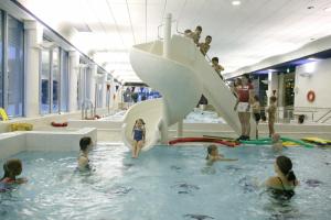 a group of people in a swimming pool at Santasport Apartment Hotel in Rovaniemi