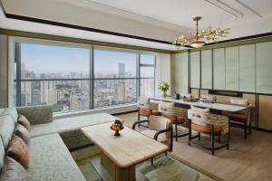 a living room with a couch and a table at Shangri-La Kunming in Kunming
