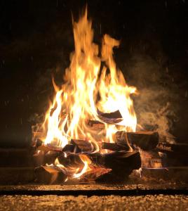 a fire is burning in a fireplace at night at Tunet in Hemavan