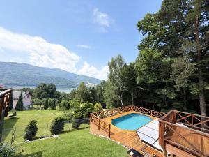 a swimming pool in a yard with a fence at Góralska Willa Bajka in Międzybrodzie Żywieckie