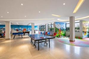 a living room with a ping pong table in it at Sterling Manali in Manāli
