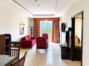 a living room with a red couch and a table at Viridi Hotels Islamabad in Islamabad