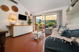a living room with a couch and a table at Angolo di Paradiso in Punta Ala