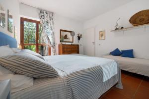a bedroom with two beds and a window at Angolo di Paradiso in Punta Ala