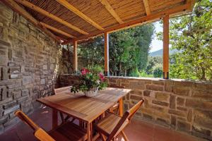 a wooden table and chairs on a patio at Angolo di Paradiso in Punta Ala
