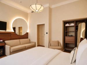 a bedroom with a bed and a couch and a mirror at Carlton Boutique Hotel - NEW OPENING in Vienna +55 photos