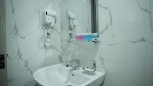 a bathroom with a sink and a mirror at Hotel City Land Tashkent in Yakkasaray