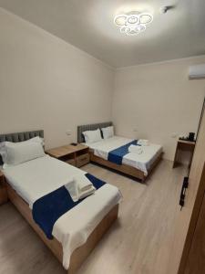 a room with two beds in a room at Hotel City Land Tashkent in Yakkasaray +13 photos