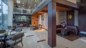 a salon with a waiting room with chairs and tables at Continent CentrePoint Makassar in Pampang