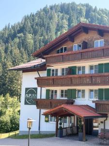 a large building with balconies on the side of it at ALPURA Allgäu - Active Nature Retreat - HOTEL REOPENING in Bad Hindelang