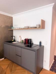 a kitchen with a black counter top in a room at ALPURA Allgäu - Active Nature Retreat - HOTEL REOPENING in Bad Hindelang +48 photos