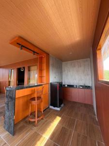 a kitchen with a counter and a refrigerator in it at De Padma Gili Air in Gili Islands