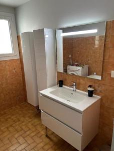 a bathroom with a sink and a mirror at Nandys lounge in Yaoundé +18 photos
