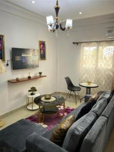a living room with a couch and a table at Nandys lounge in Yaoundé