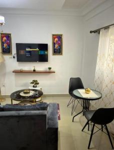 a living room with a couch and a table at Nandys lounge in Yaoundé