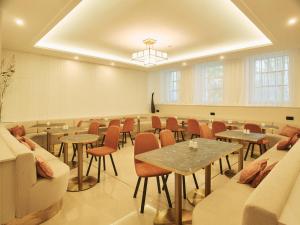 a large room with tables and chairs and a room with a room at Carlton Boutique Hotel - NEW OPENING in Vienna