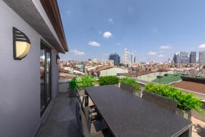 a balcony with a table and a view of the city at Redmont Hotel Nisantasi in Istanbul