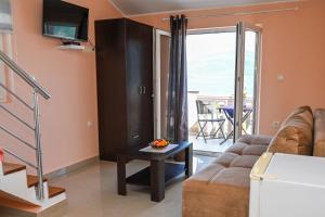 a living room with a couch and a table at Apartments Porto Bjelila in Tivat