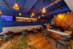 a restaurant with blue walls and tables and chairs at Redmont Hotel Nisantasi in Istanbul