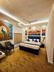 a bedroom with a bed and a painting on the wall at Lucknow Courtyard in Lucknow +32 photos
