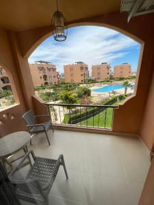 a view from the balcony of a resort with a view of a pool at Furnished Chalet Apartment at La Hacienda Ras Sedr in Ras Sedr