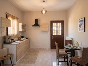 a kitchen with a table and a dining room at Villa Rozalia in Konitsa
