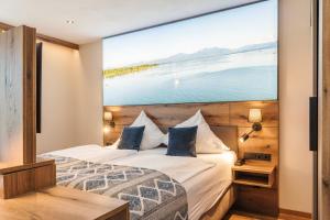 a hotel room with a large painting on the wall at Hotel Schlossblick Chiemsee in Prien am Chiemsee