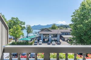 a view of a town with cars parked in a parking lot at Hotel Schlossblick Chiemsee in Prien am Chiemsee