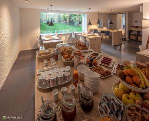a table filled with lots of food in a living room at Le Palme City Rooms & Breakfast in Trento