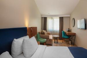 a hotel room with a bed and a living room at Redmont Hotel Nisantasi in Istanbul