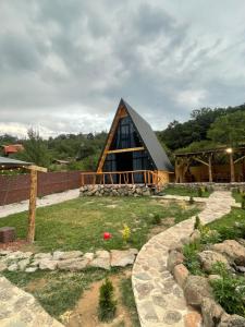a large wooden house with a gambrel roof at Hayrapet Asatryan in Arzakan