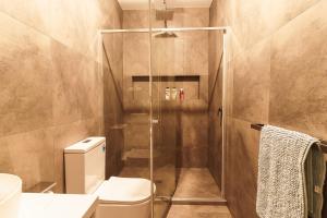 a bathroom with a toilet and a glass shower at Light-Filled Werribee Escape in Werribee +50 photos