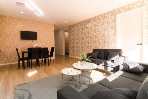 a living room with a couch and a table at Light-Filled Werribee Escape in Werribee