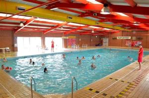 a group of people swimming in a swimming pool at 3 bed static van with decking in Dymchurch
