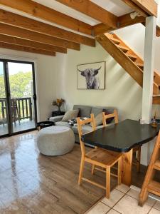 a living room with a table and a couch at Turicum AT Monkey Rock Winery & Cider in Parryville +48 photos