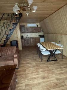 a dining room with a table and chairs and a staircase at Hayrapet Asatryan in Arzakan