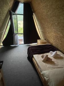 a bed in a room with a window at Hayrapet Asatryan in Arzakan +14 photos