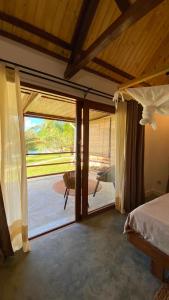 a bedroom with a bed and a large sliding glass door at Ankavia Lodge in Sainte Marie +24 photos