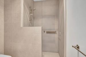 a shower with a glass door in a bathroom at Stylish 3-Bedroom Townhouse Near Shops & Parks in Point Cook +24 photos