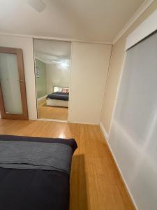 a bedroom with a bed and a large mirror at Yokomokko House in Bridgewater