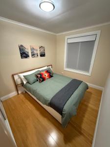 a bedroom with a large bed with a window at Yokomokko House in Bridgewater