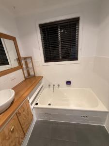 a white bathroom with a tub and a sink at Yokomokko House in Bridgewater +161 photos